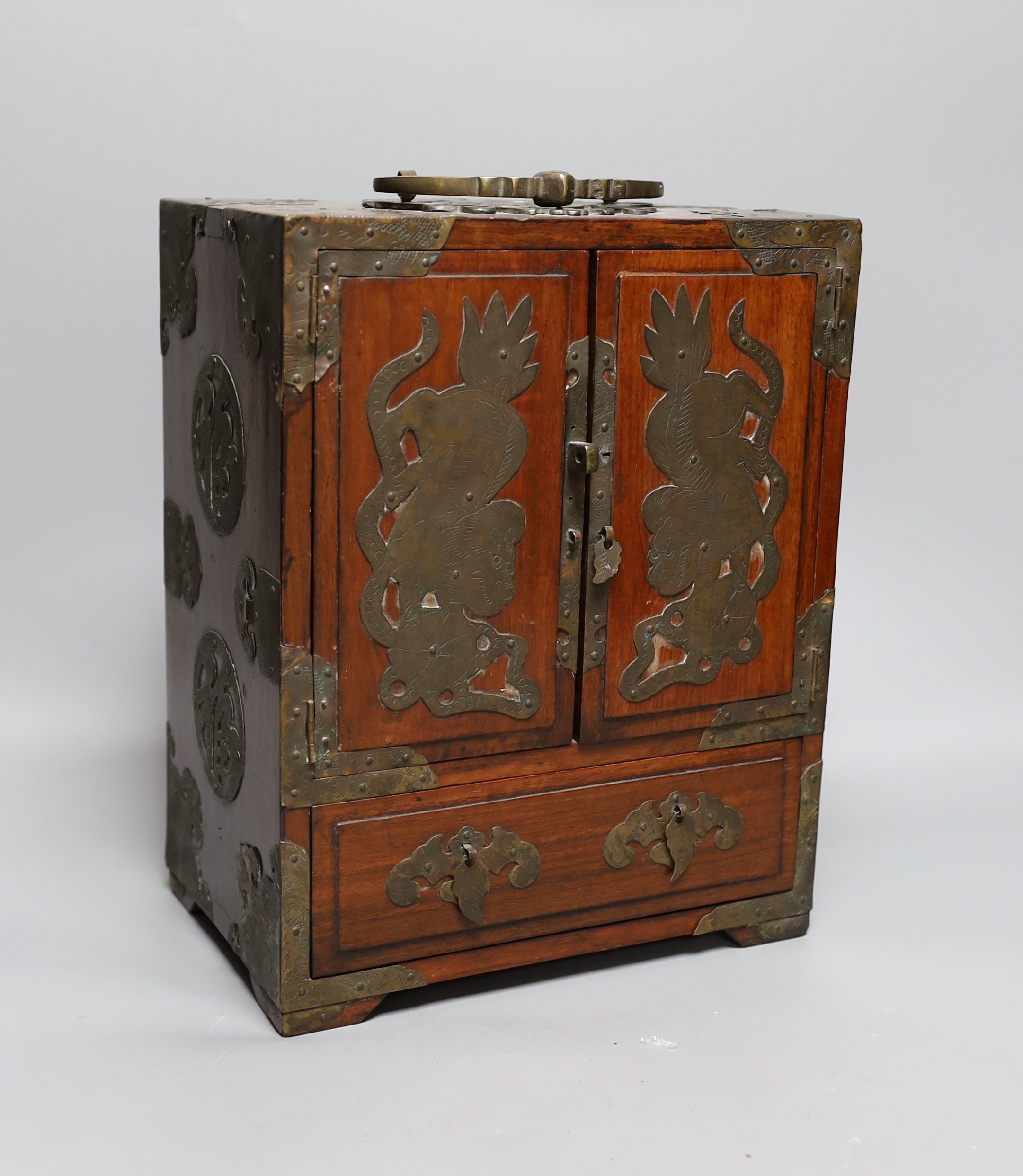 A Chinese brass mounted two door, five drawer cabinet, 29 cms high